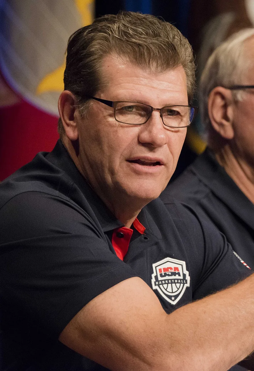 Geno Auriemma seated in a black USA Basketball polo shirt