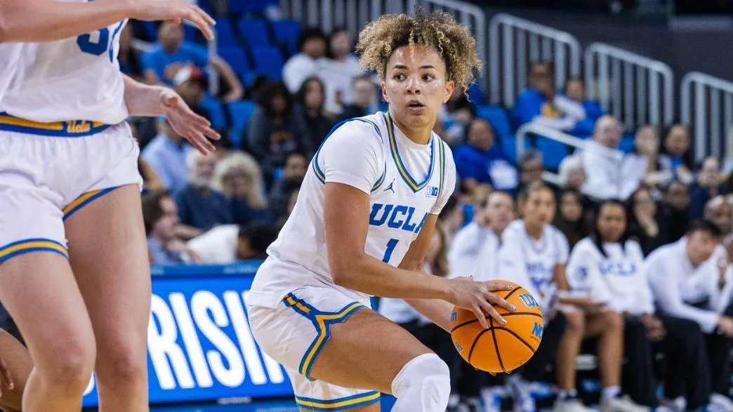 A UCLA women's basketball player holds the ball during a game