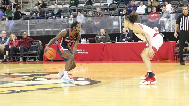 Antoine Davis taking a shot for Detroit Mercy during a college basketball game