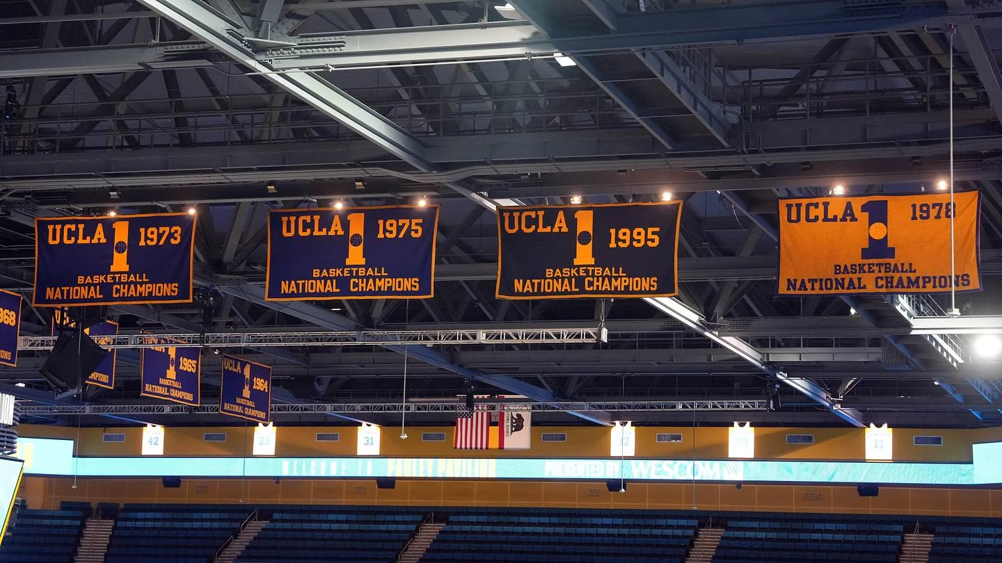 UCLA men's basketball championship banners displayed inside an arena