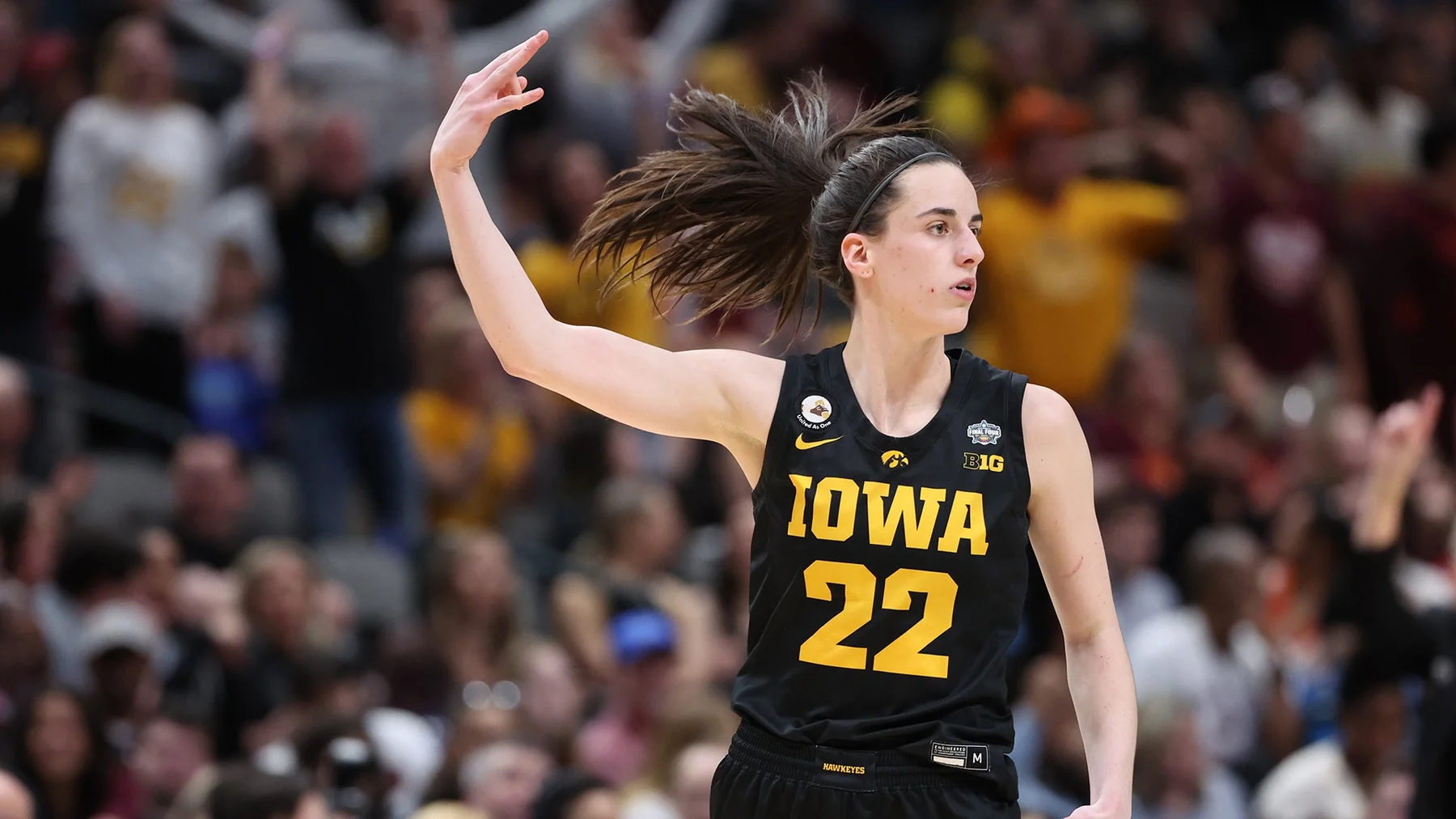 Caitlin Clark handling the ball for Iowa during an NCAA women's basketball game